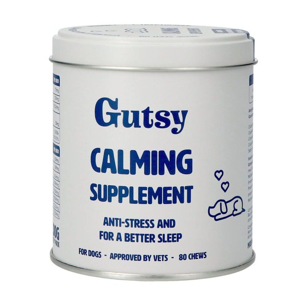 Witte, cilindrische verpakking met blauwe tekst: Gutsy Calming Supplement. Bevat 80 kauwsnacks. Voor honden.