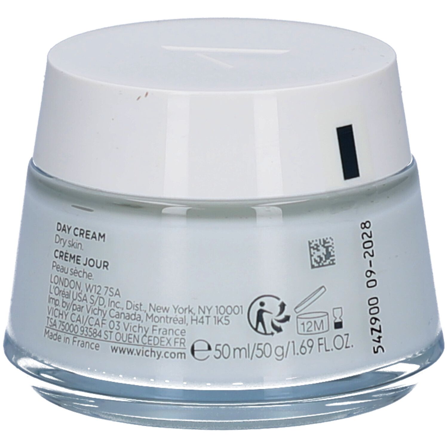 Crèmepot met witte deksel. Opschrift: Day Cream, Crème Jour. Achterkant met tekst en codes.