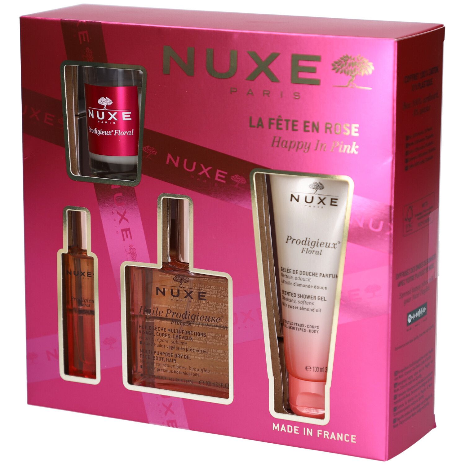 Coffret rose avec quatre produits. Visibles : flacon, huile, gel douche et bougie. Logo et texte Nuxe.