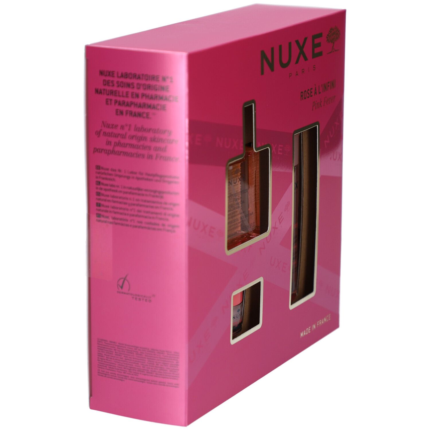 Coffret rose, vue latérale. Logo Nuxe et noms de produits visibles. Ouvertures pour les produits.