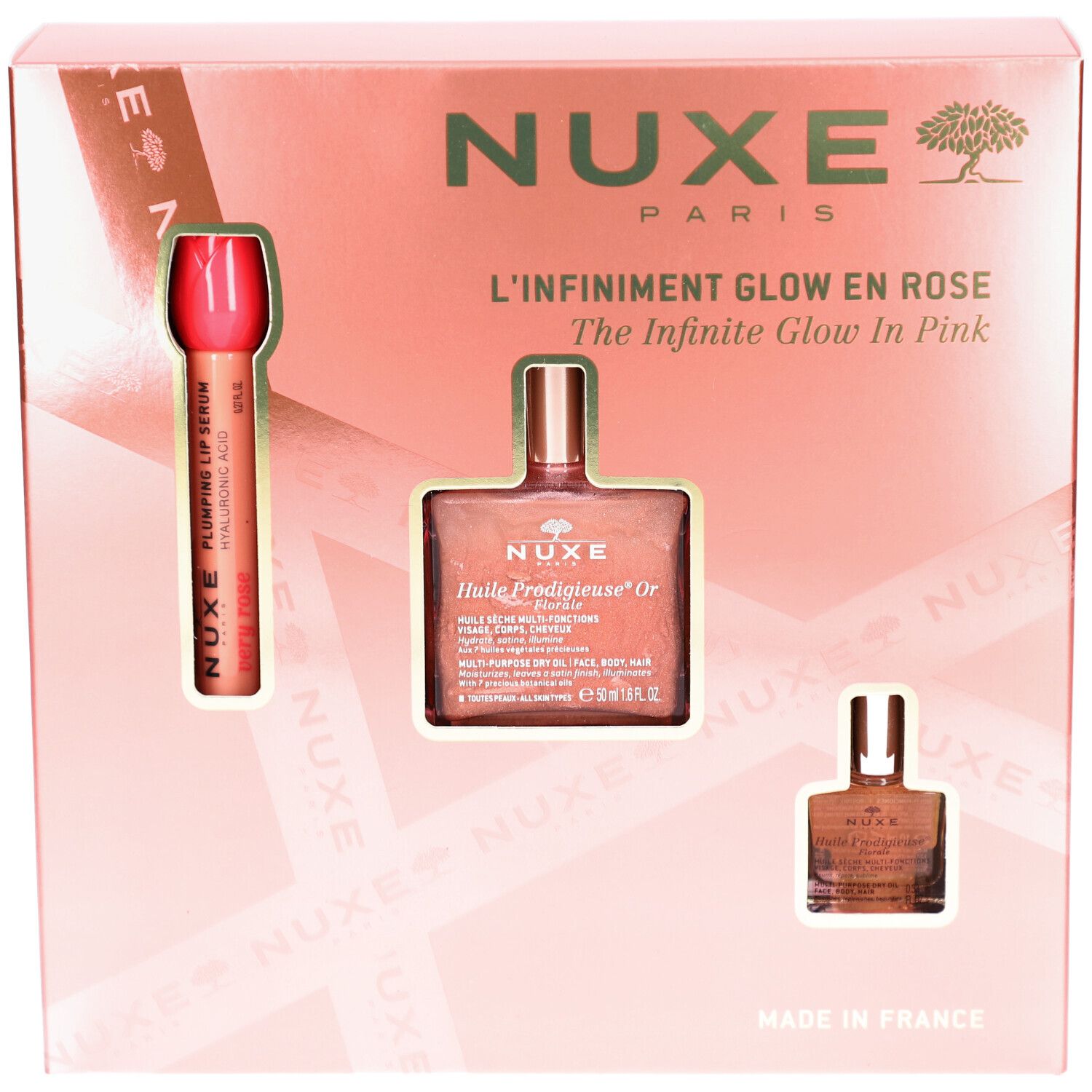 Coffret cadeau rose avec trois produits. Visibles: rouge à lèvres, flacon d'huile et petit flacon. Texte: Nuxe Paris, Glow en Rose.