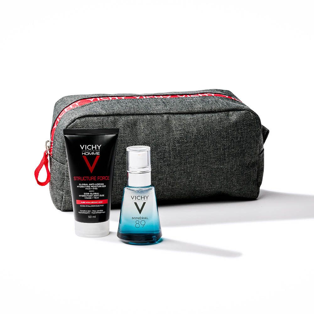 Trousse de toilette grise avec fermeture éclair rouge. Contient deux produits : crème et sérum. Fond blanc.