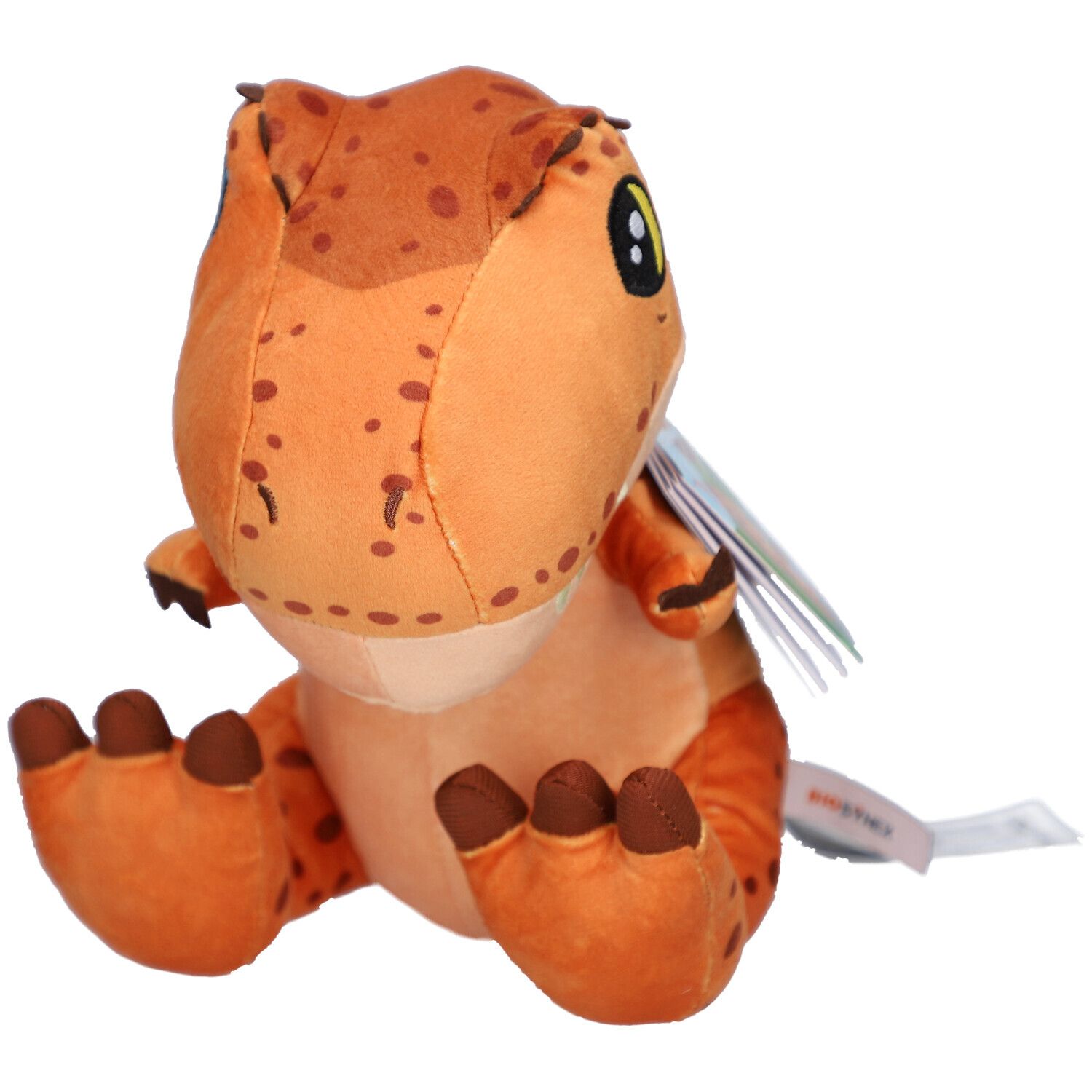 Oranje T-Rex knuffel. Met bruine vlekken en grote ogen. Een label is aan het product bevestigd.