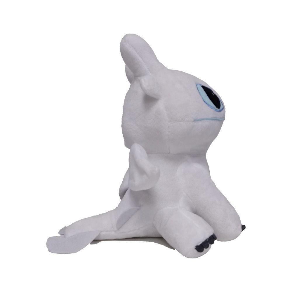 Wit pluche dier, zijaanzicht. Draakvorm, blauwe ogen, vleugels. Liggende positie.