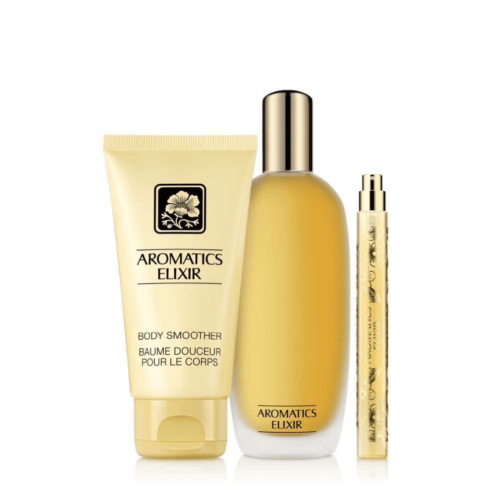 Drie Clinique Aromatic Elixir producten: body smoother, parfumfles en verstuiver. Crème- en goudkleurig.