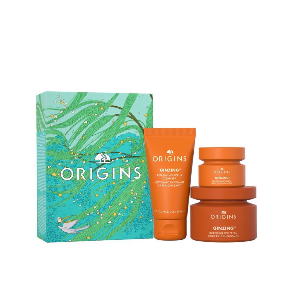 Coffret cadeau avec trois pots oranges et un tube. L'emballage présente le logo Origins.