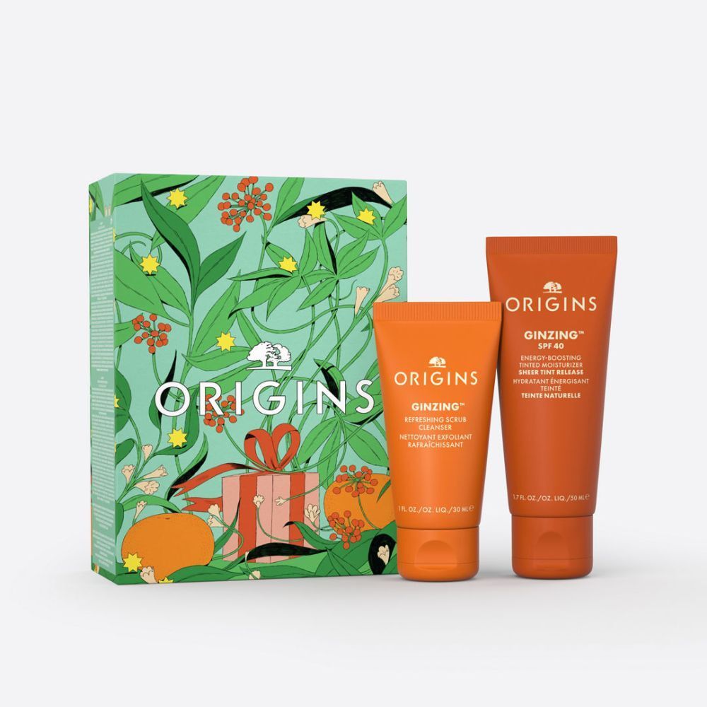 Cadeauverpakking met twee oranje tubes. De tubes dragen de opschriften "GINZING" en "ORIGINS".