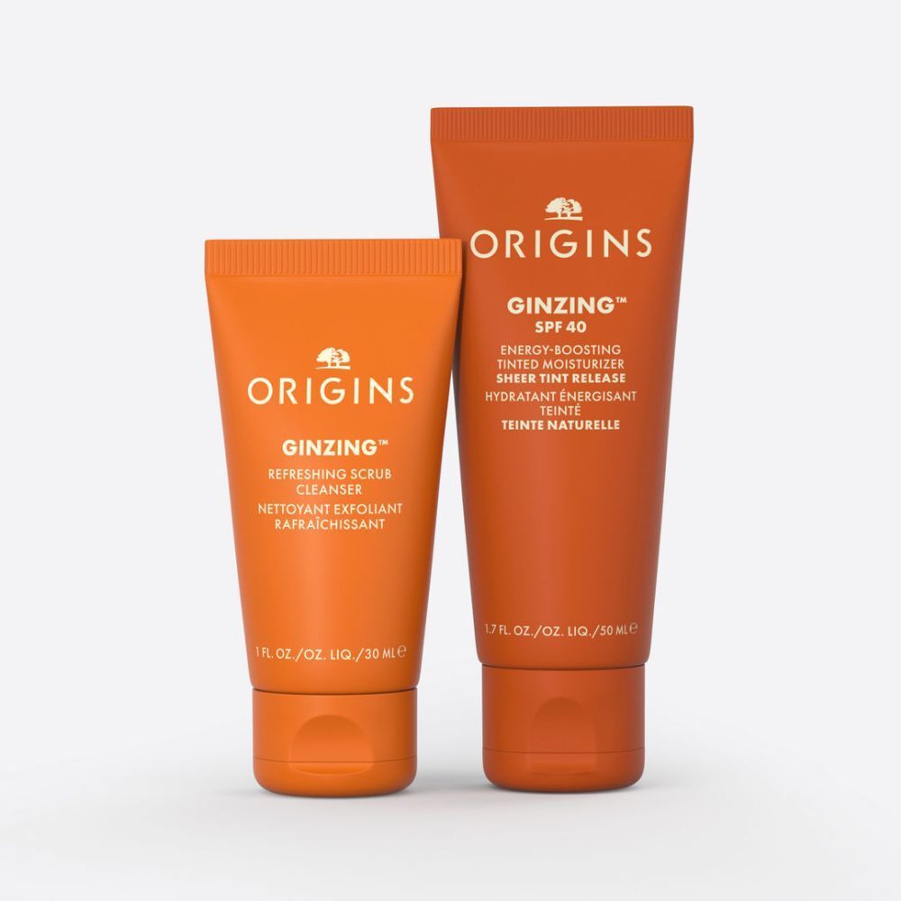 Deux tubes oranges avec les inscriptions "ORIGINS" et "GINZING".