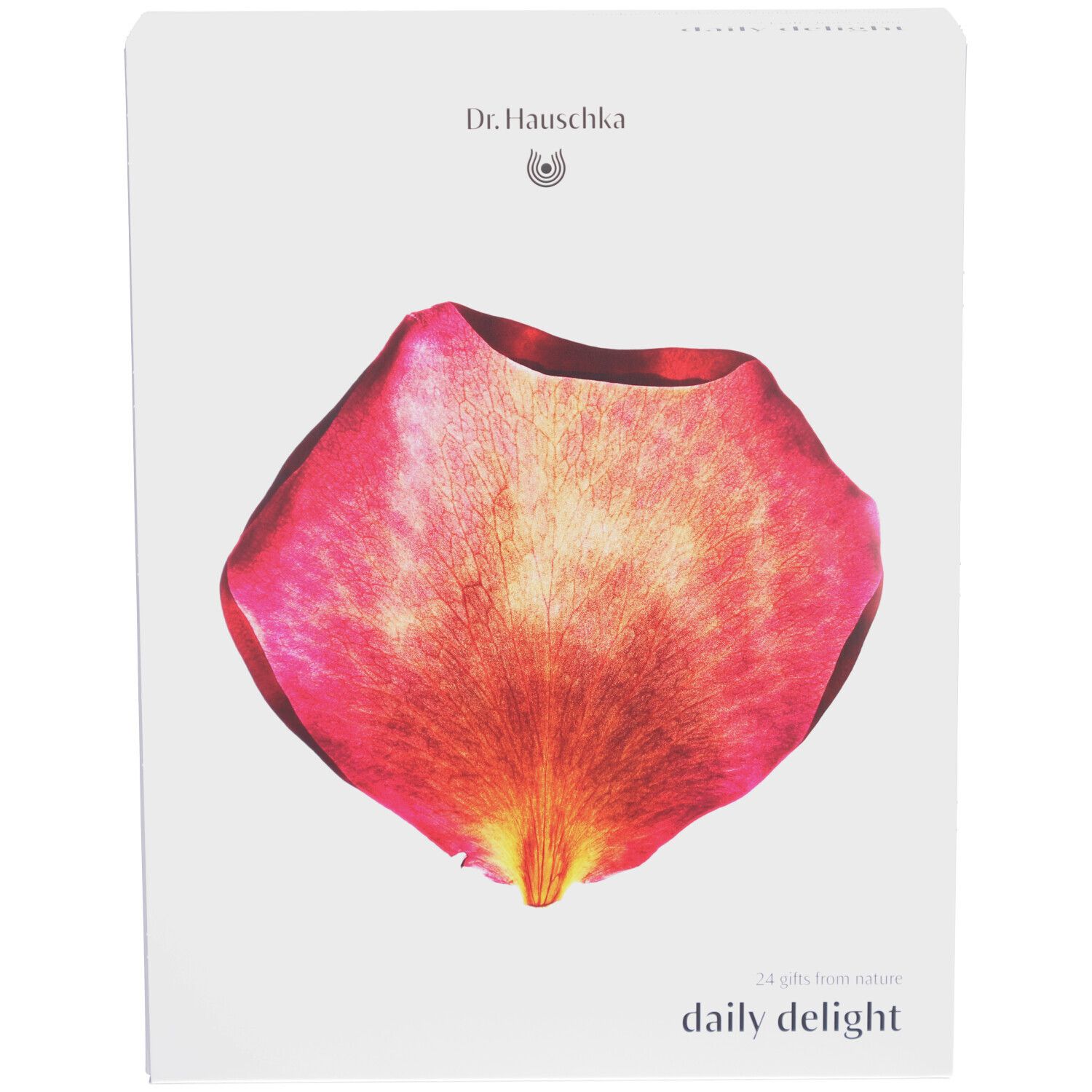 Boîte blanche avec logo Dr. Hauschka et pétale de rose. Inscription : Daily Delight. 24 cadeaux de la nature.