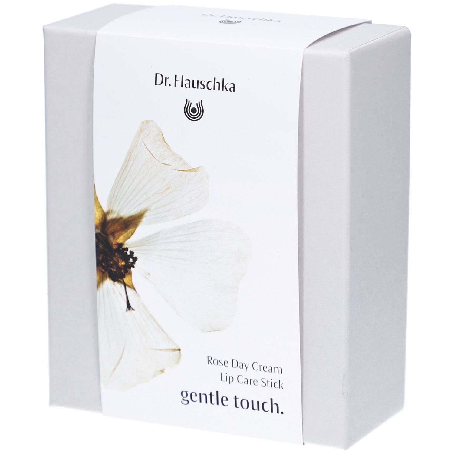 Witte doos met etiket. Opschrift: Dr. Hauschka, Rose Day Cream, Lip Care Stick, gentle touch.