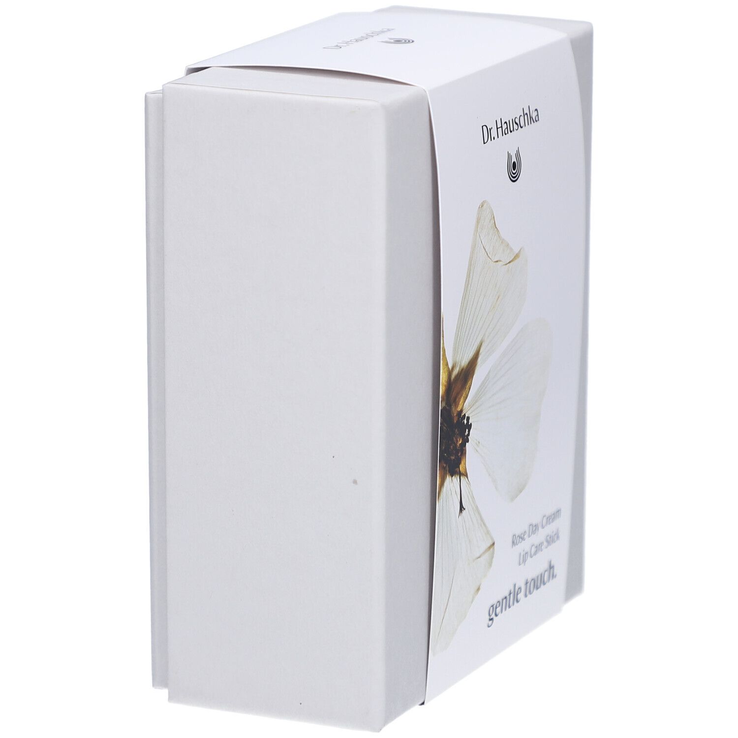 Witte doos, zijaanzicht. Etiket met: Dr. Hauschka, Rose Day Cream, Lip Care Stick.