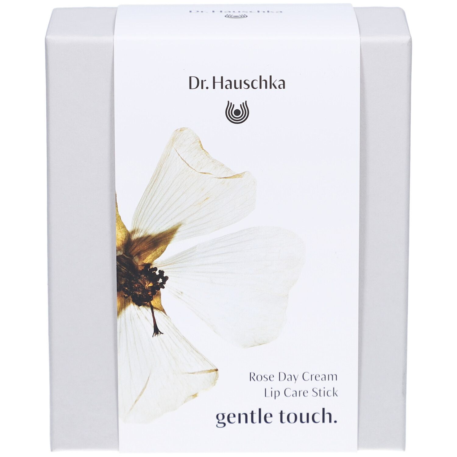 Witte doos met etiket. Opschrift: Dr. Hauschka, Rose Day Cream, Lip Care Stick, gentle touch.