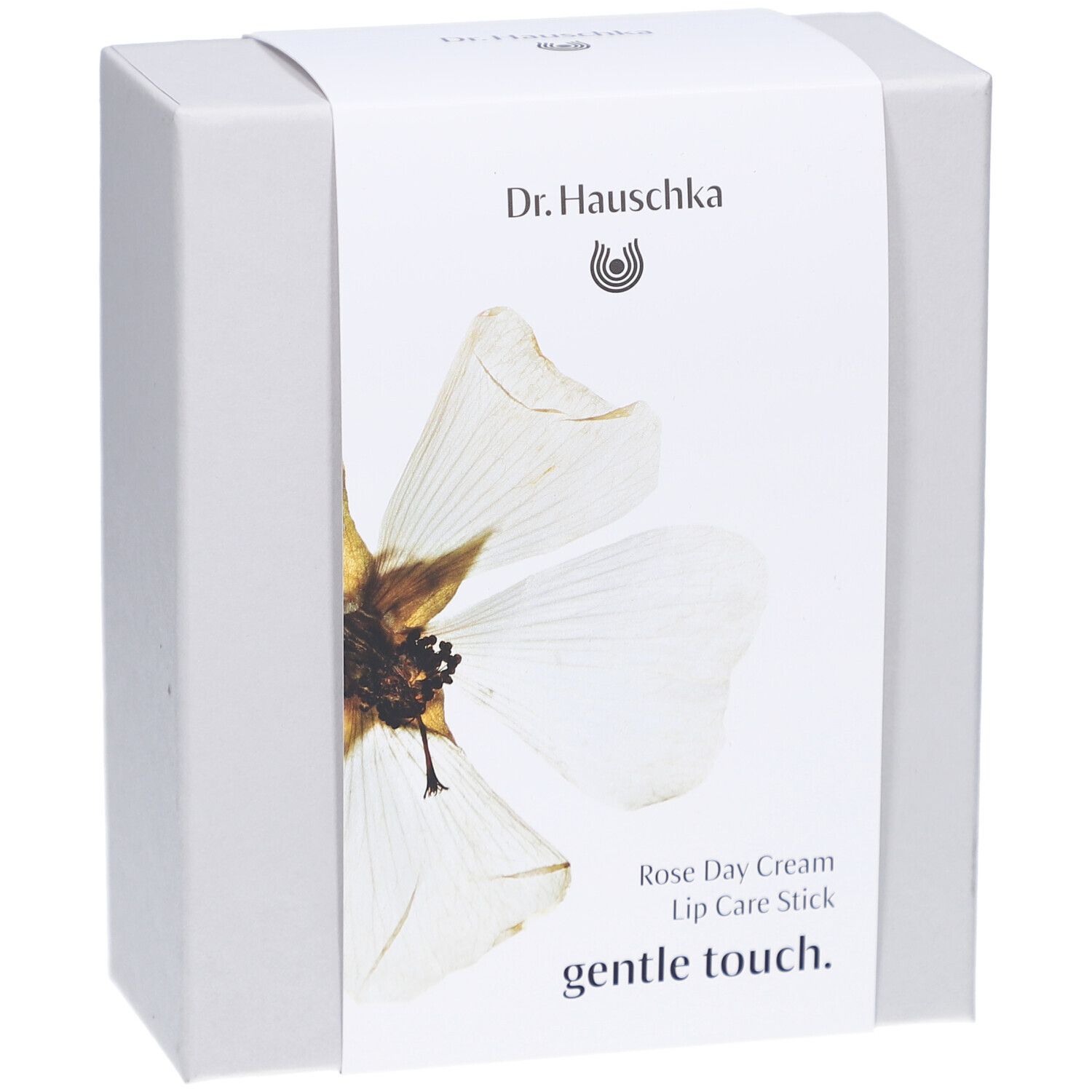 Witte doos met etiket. Opschrift: Dr. Hauschka, Rose Day Cream, Lip Care Stick, gentle touch.