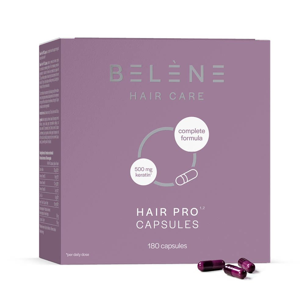 Gélules rouge foncé à côté d'une boîte rose. Inscription : Belène Hair Care, Hair Pro Capsules, 180 capsules.