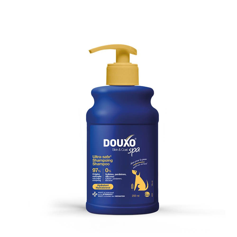 Flacon bleu avec pompe jaune. Inscription DOUXO Skin & Coat spa. Ultra-safe Shampooing. Hydratant. Symbole de chien.