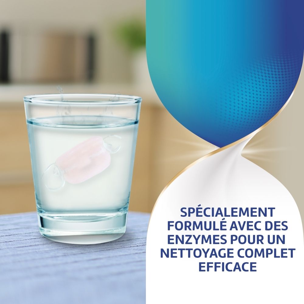 Comprimé dans un verre d'eau. Inscription: Spécialement formulé avec des enzymes pour un nettoyage complet efficace.