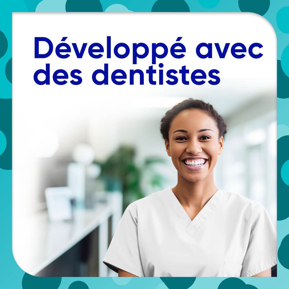 Femme souriante en blouse blanche. Texte : Développé avec des dentistes (Développé avec des dentistes).