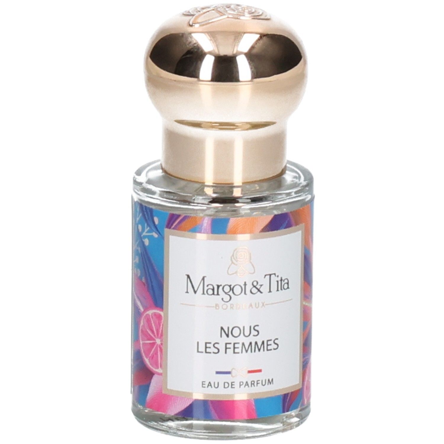 Flacon de parfum avec bouchon doré et étiquette colorée 'Margot & Tita NOUS LES FEMMES EAU DE PARFUM'.