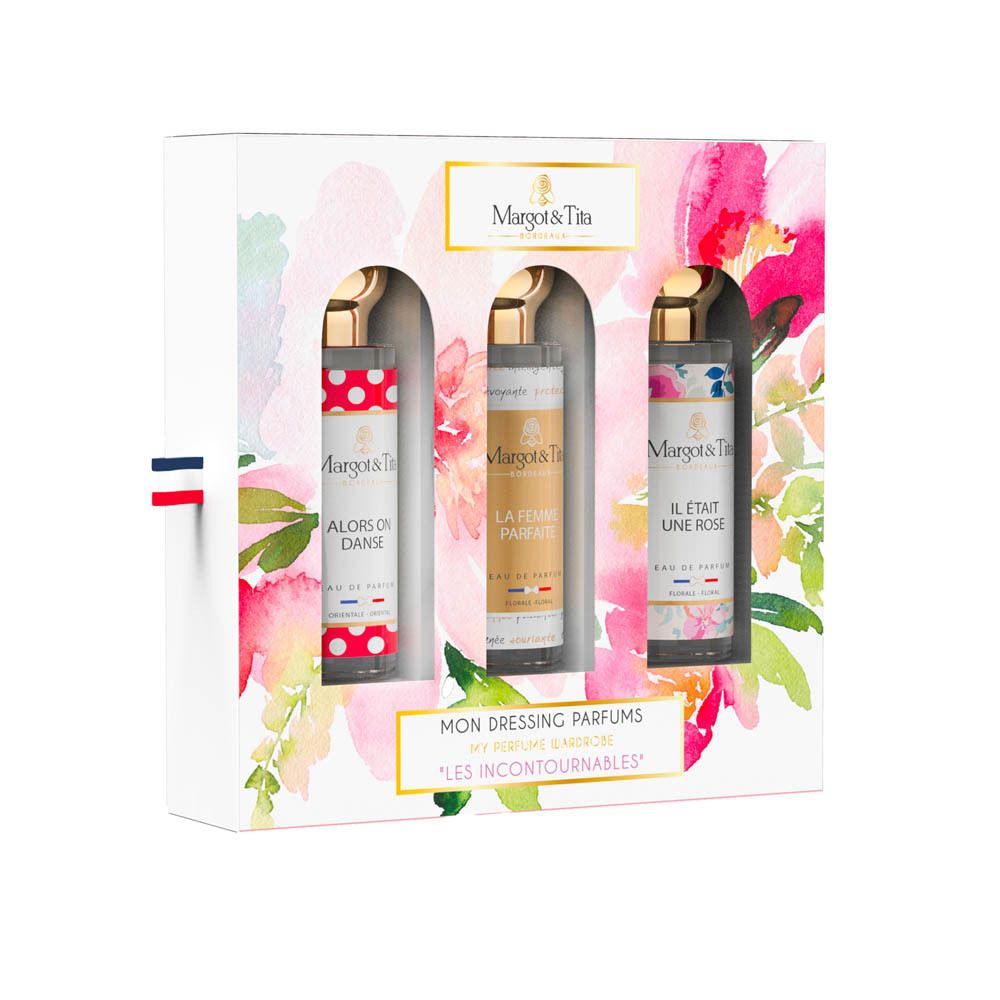 Geschenkverpakking met drie parfums. Witte doos met bloemmotieven en productnamen. Gouden doppen en Franse vlag.
