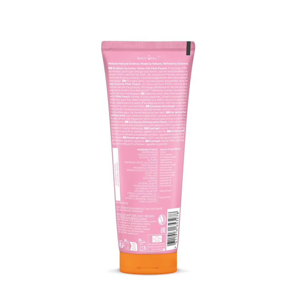 Dos d'un tube rose avec bouchon orange. Texte multilingue. Code-barres et symboles.