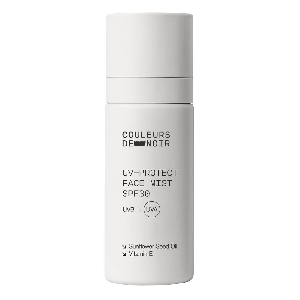 Flacon pulvérisateur blanc avec inscription 'COULEURS DE NOIR UV-PROTECT FACE MIST SPF30'.