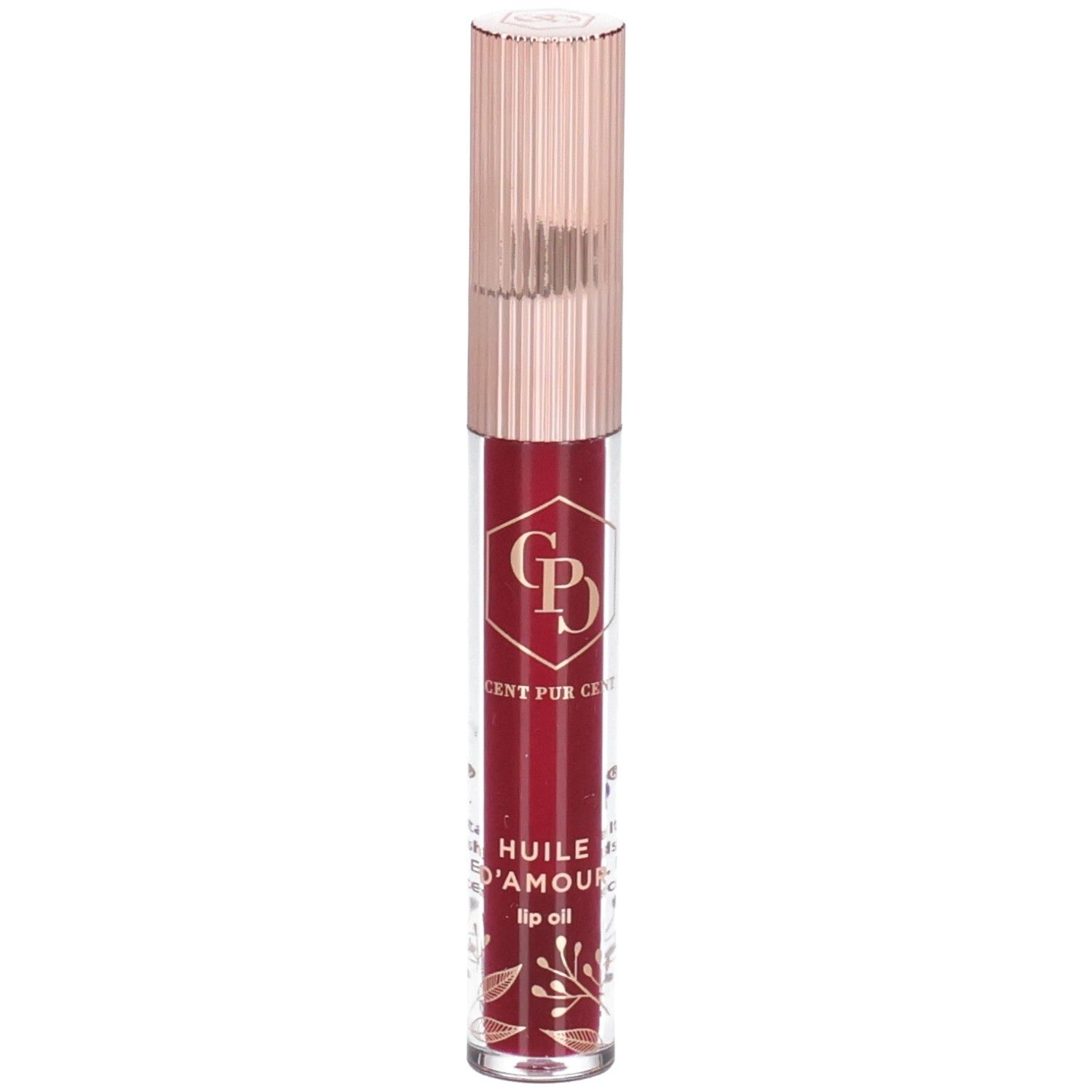Huile à lèvres dans un flacon transparent avec un bouchon or rose. Le contenu est rouge. Des décorations dorées sont visibles sur le flacon.