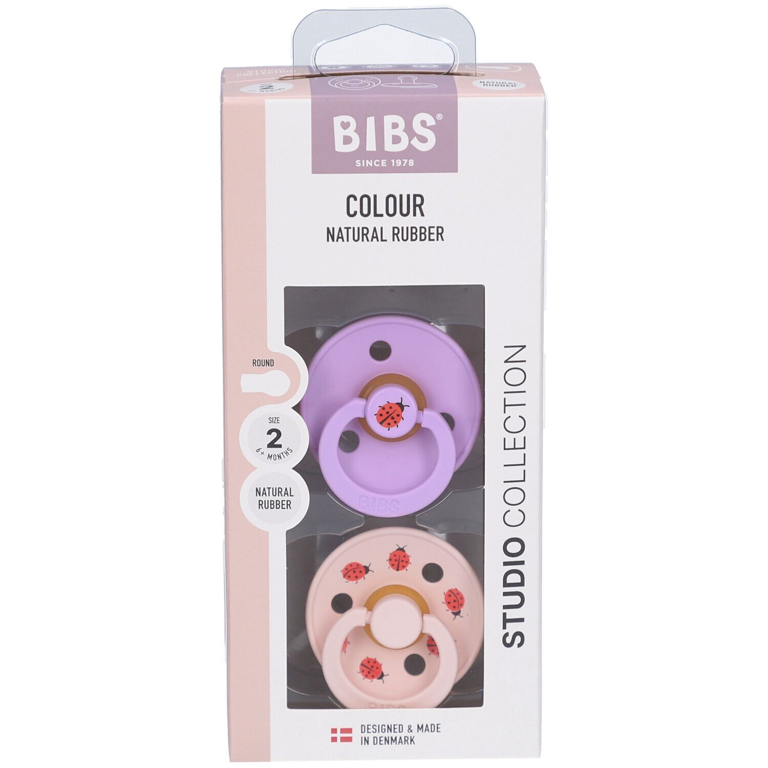Boîte de deux sucettes. Tétines violettes et roses avec motifs coccinelles. Caoutchouc naturel. Marque BIBS.