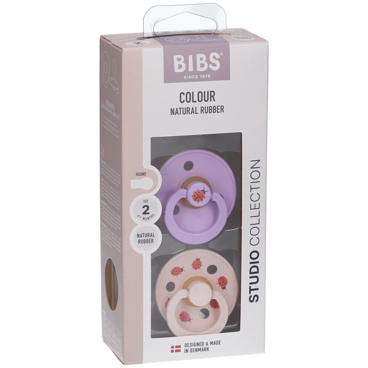 Boîte de deux sucettes. Tétines violettes et roses avec motifs fraises. Caoutchouc naturel. Marque BIBS.