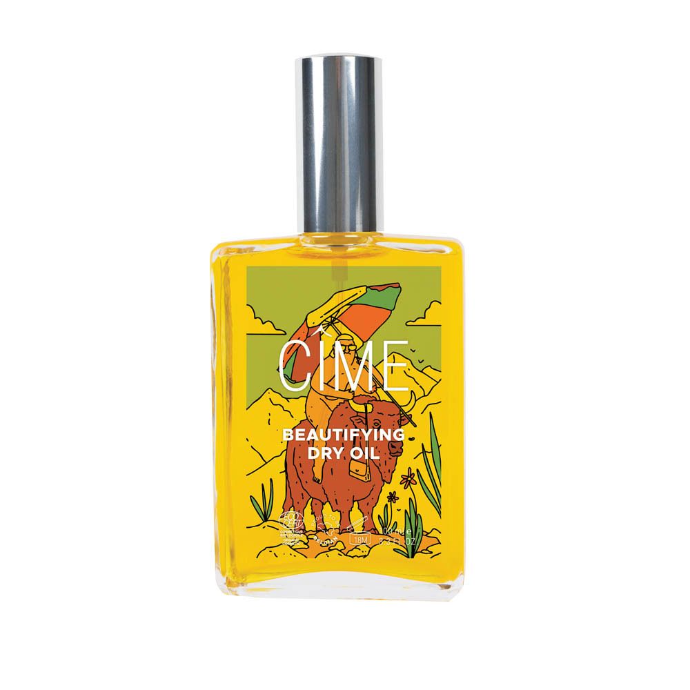 Gele glazen fles met zilveren dop. Etiket met illustratie en tekst: CIME, Beautifying Dry Oil.