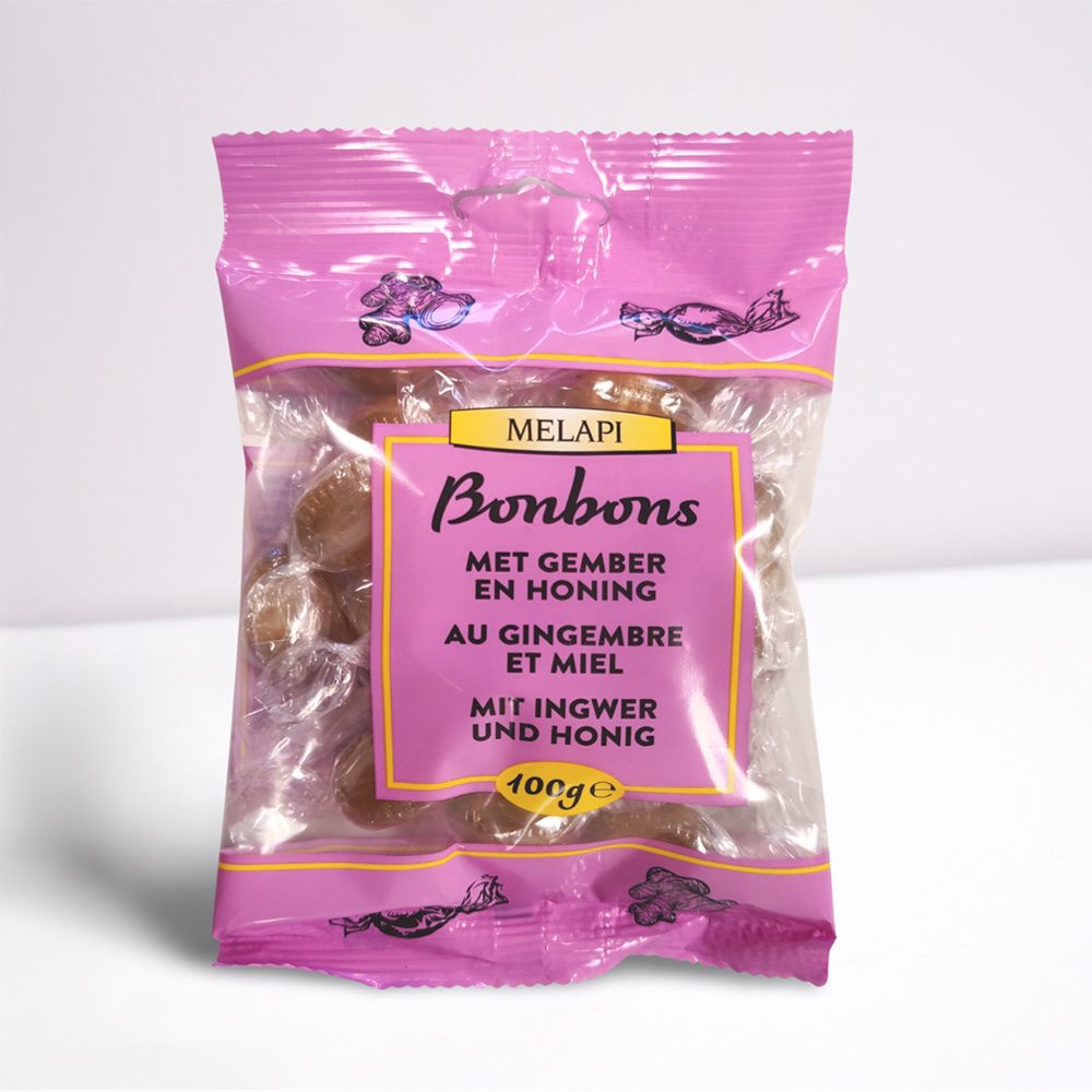 Roze verpakking met bonbons. Opschrift: Melapi Bonbons, gember en honing. 100g.
