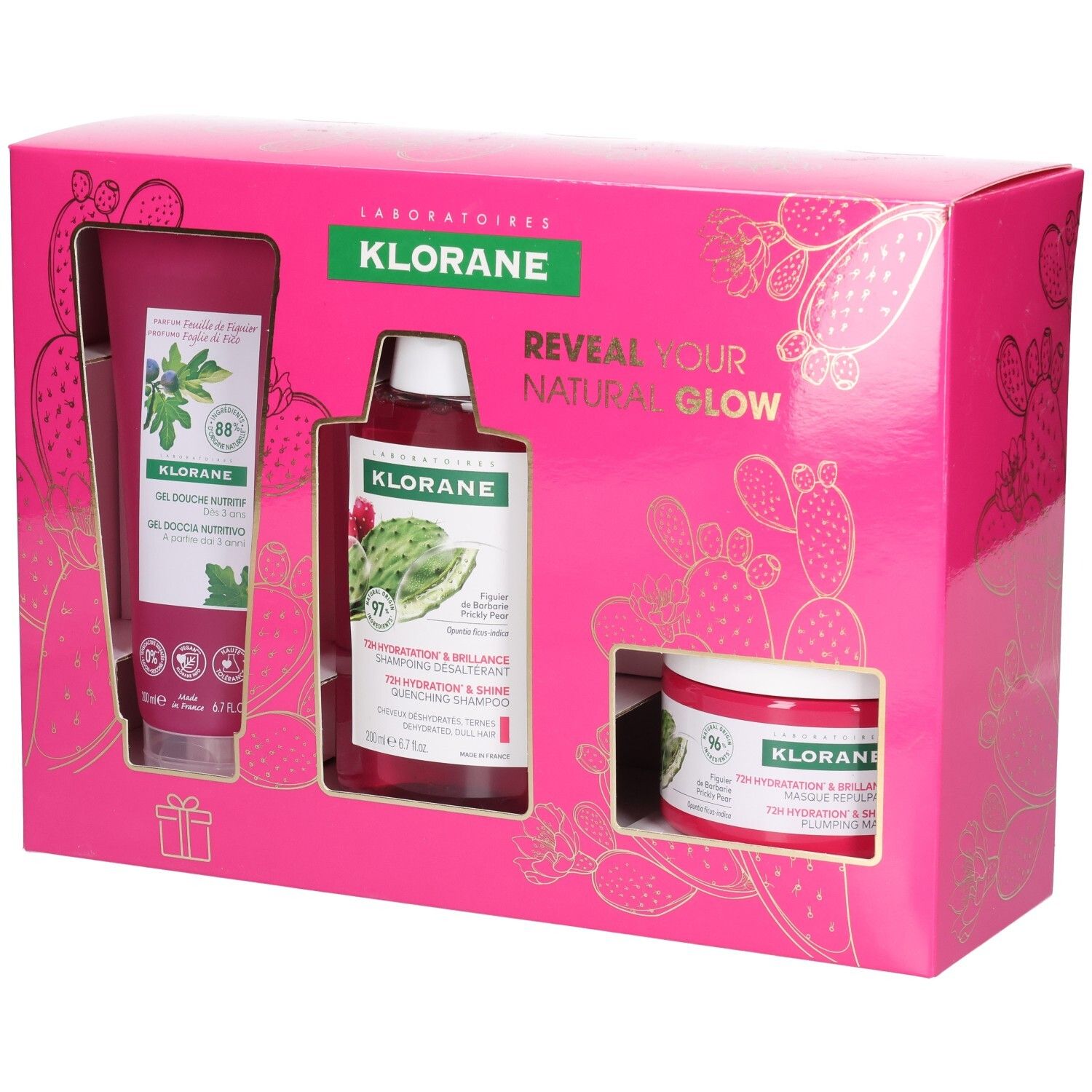 Roze Klorane cadeauverpakking met douchegel, shampoo en crème. Gouden cactus design. Tekst: "Reveal your natural glow".