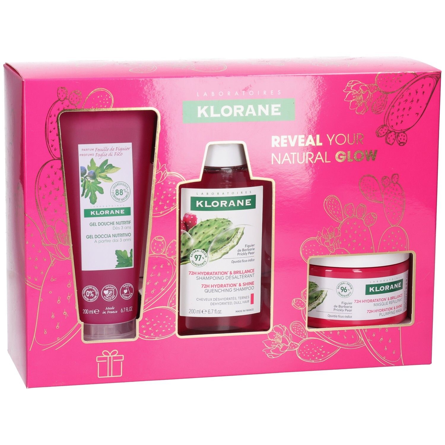 Roze Klorane cadeauverpakking met douchegel, shampoo en crème. Gouden cactus design. Tekst: "Reveal your natural glow".