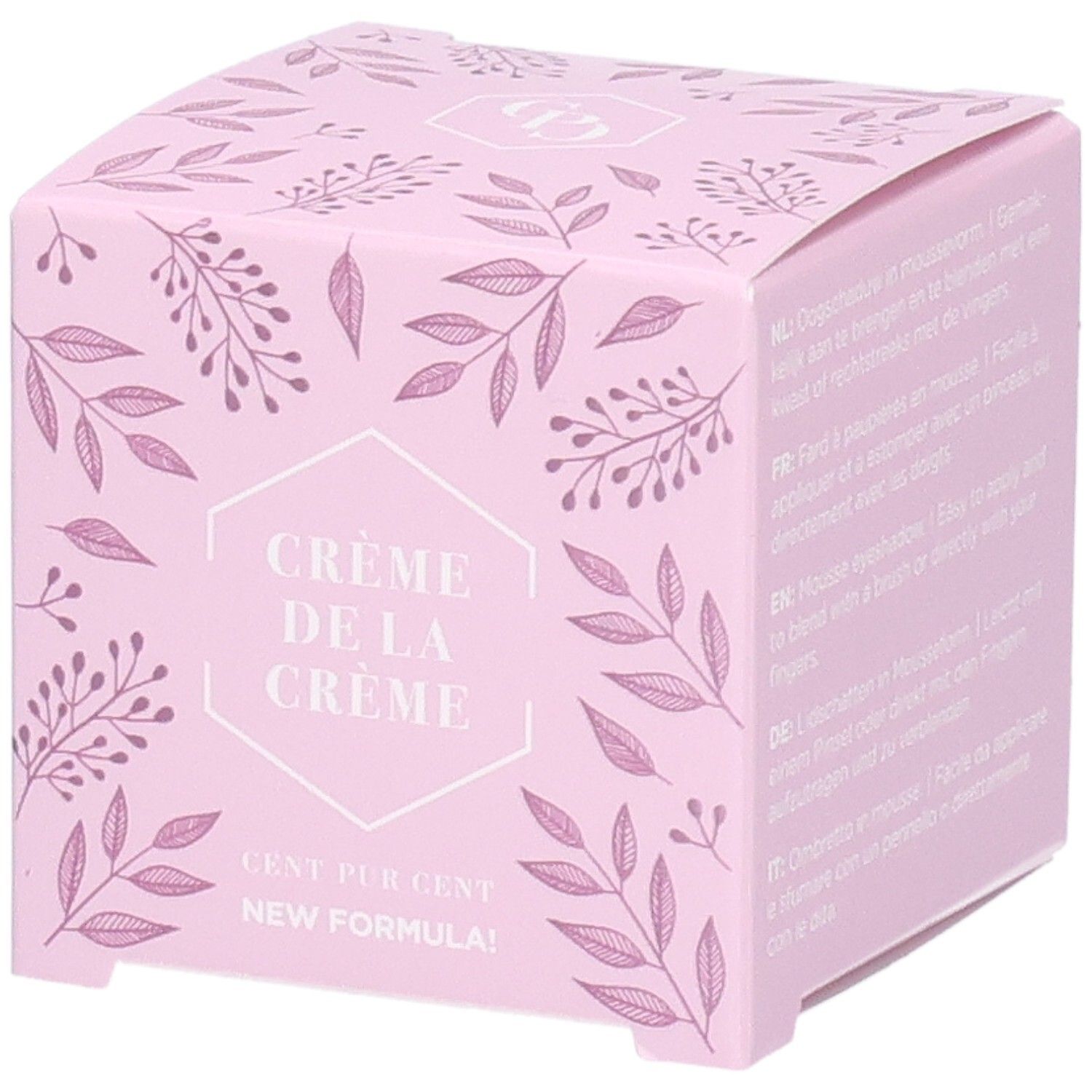 Boîte rose avec motif floral. Texte: Crème de la Crème, Cent Pur Cent, New Formula. Instructions multilingues d'utilisation.