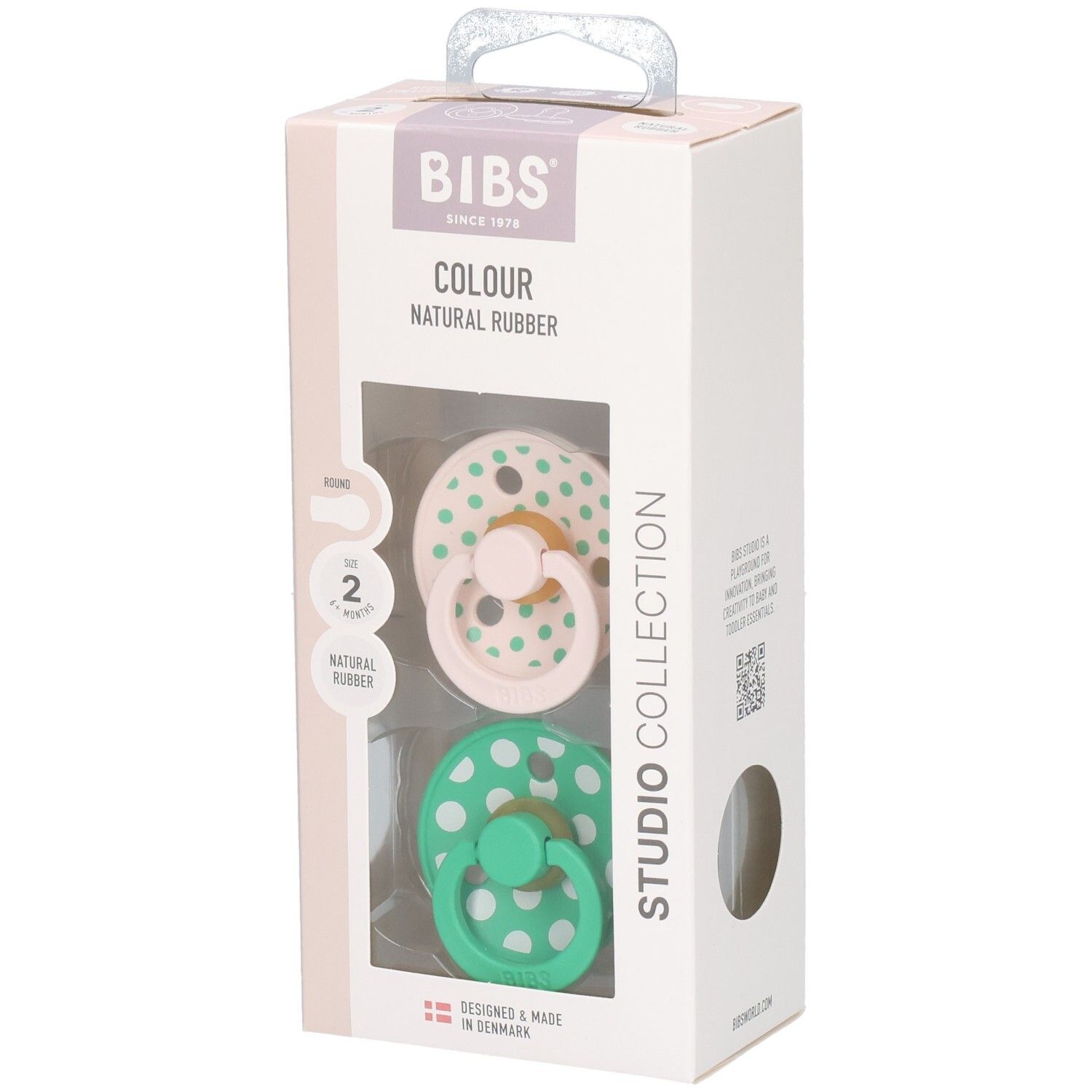 Verpakking met twee fopspenen. Roze en groene spenen met witte stippen. Merk: BIBS. Natuurrubber.