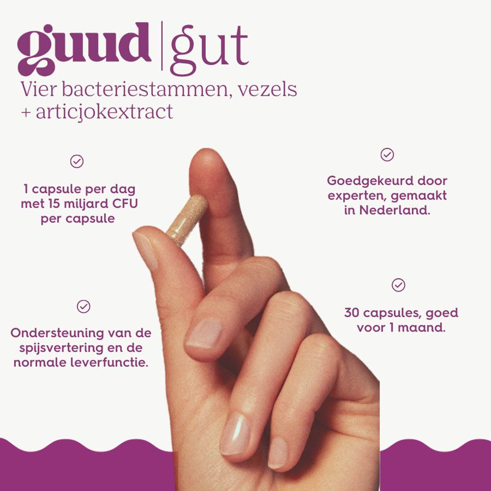 Hand houdt capsule vast. Tekst: Guud Gut, 4 bacteriestammen, vezels + artisjokextract. 1 capsule per dag, 30 capsules.