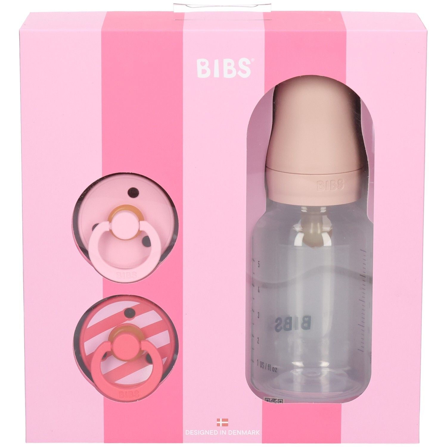 Roze geschenkverpakking met fopspenen en fles. BIBS-logo. Transparante fles met schaalverdeling. Twee spenen.
