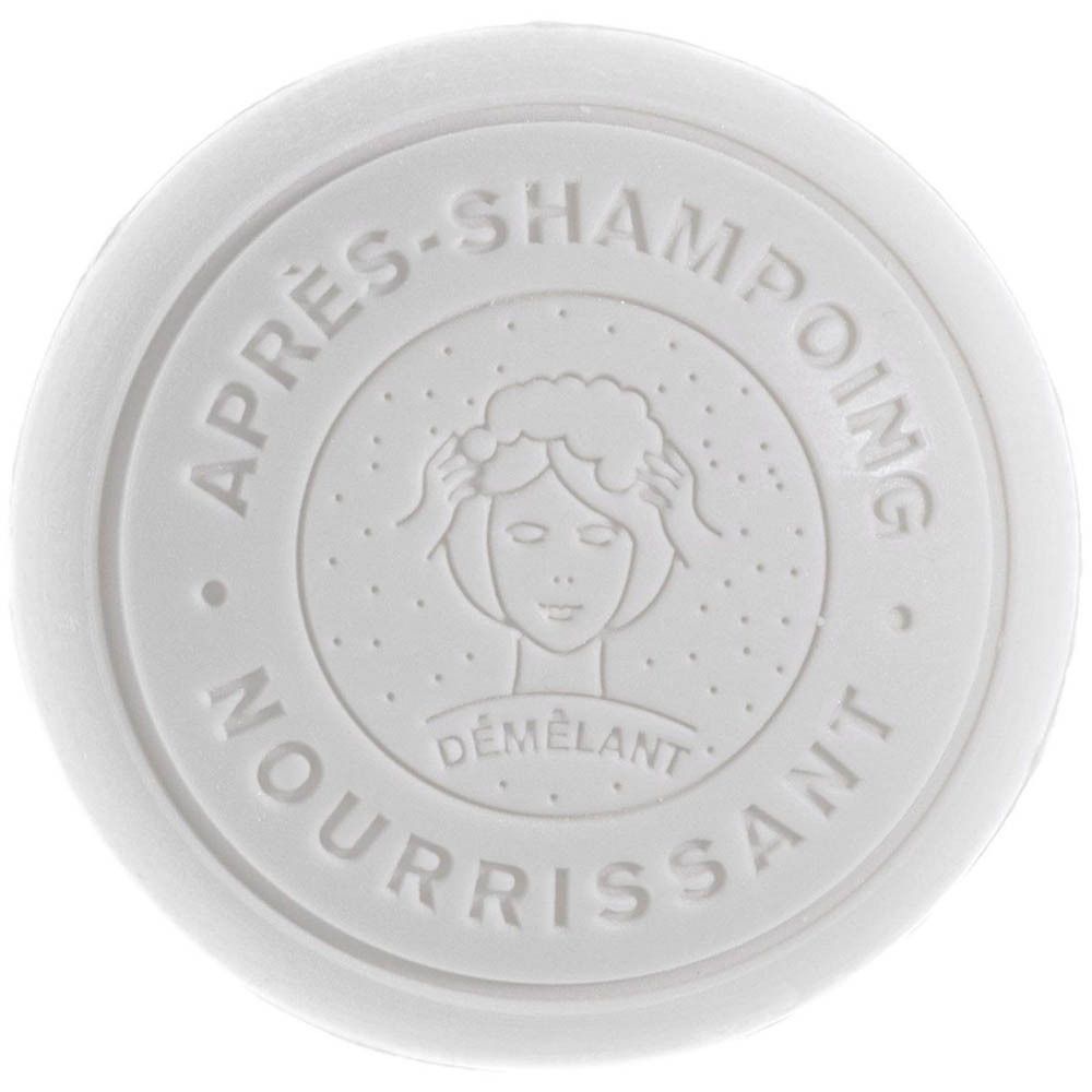 Ronde witte deksel met reliëf: "APRÈS-SHAMPOING NOURRISSANT DÉMÊLANT" en vrouwensymbool.