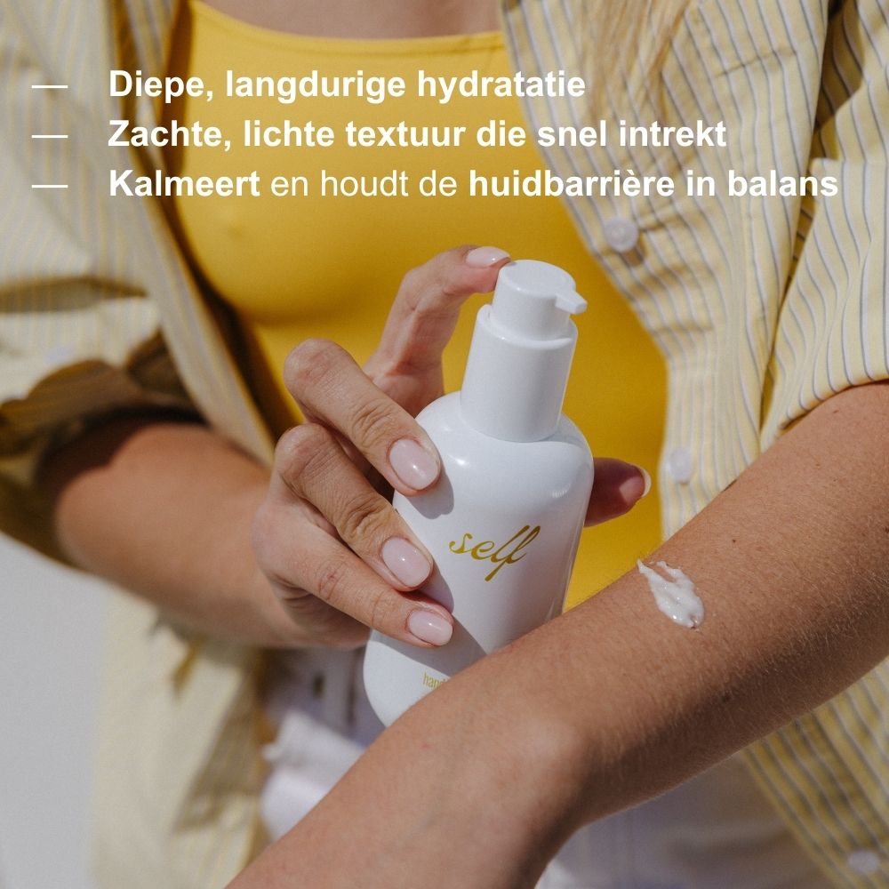 Achterkant van een witte lotionfles met pompdosering, gouden tekst met productinformatie en zegels.