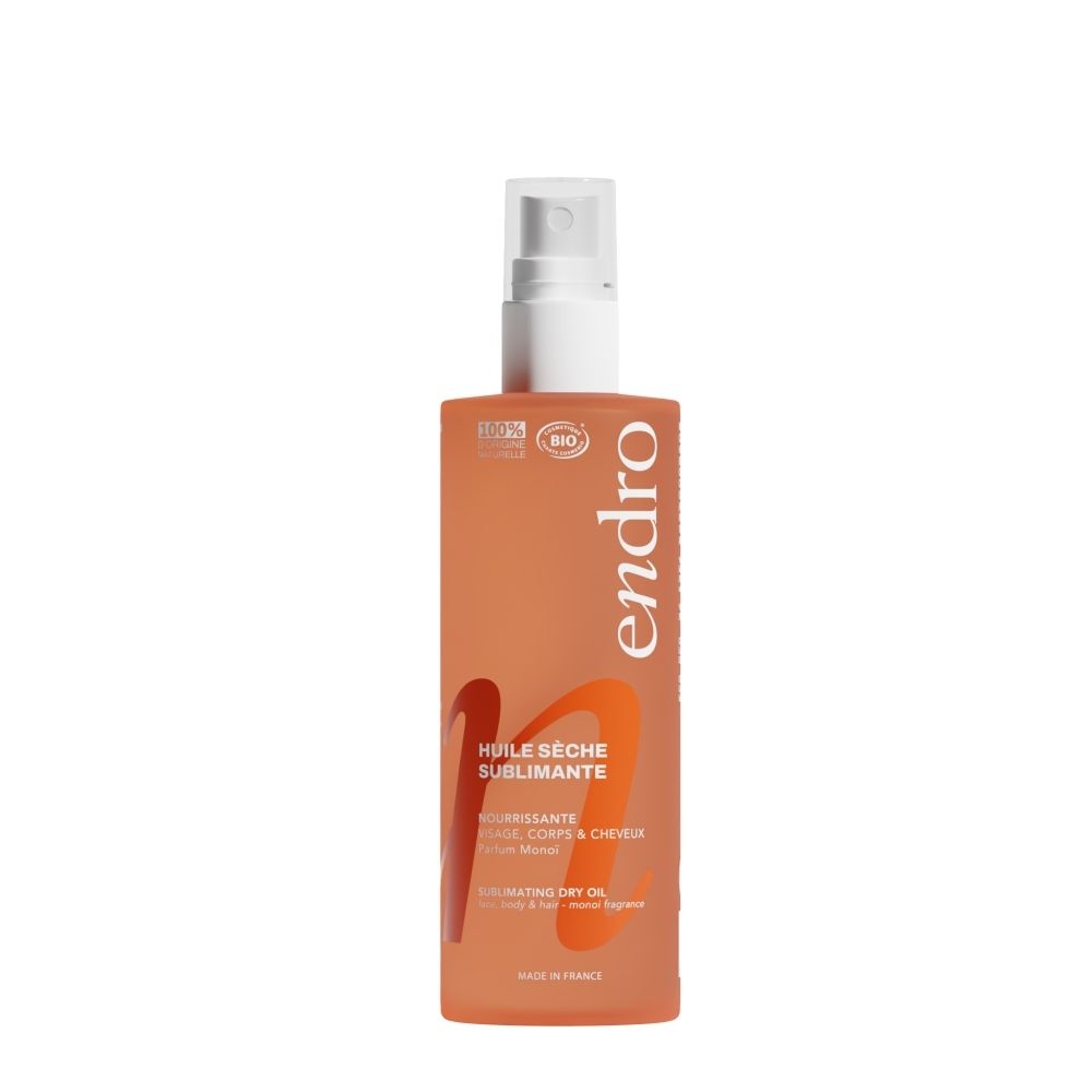 Oranje spuitfles met Endro logo en tekst 'Huile Sèche Sublimante'.