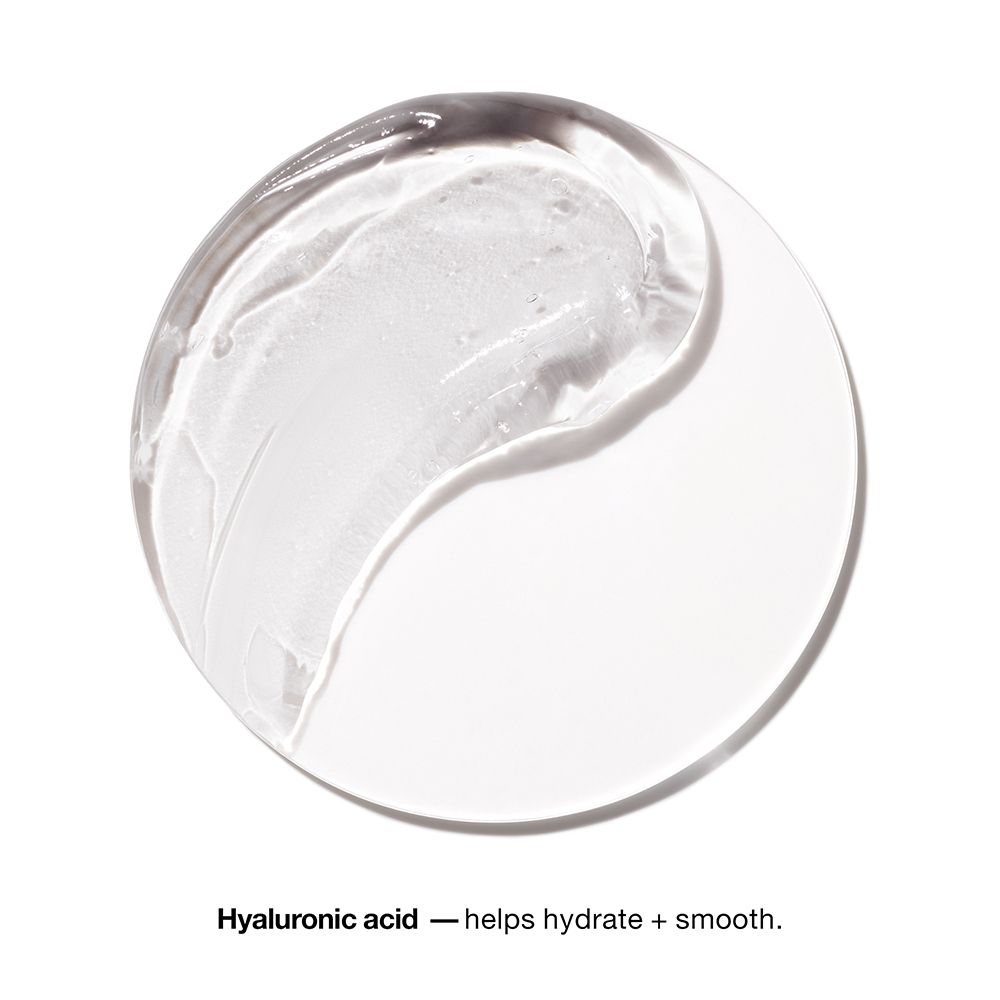 Rond, transparant oppervlak met heldere crème. Tekst: Hyaluronic acid - helps hydrate + smooth.