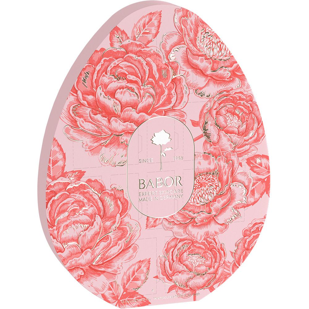 Emballage en forme d'œuf avec motif floral et logo Babor. Fond rose, détails dorés. Pas d'ampoule visible.