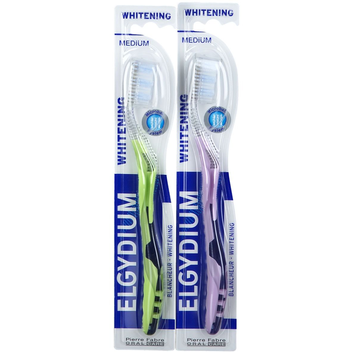 Deux brosses à dents sous blister. Manches verts et violets. Inscriptions "ELGYDIUM" et "Whitening".