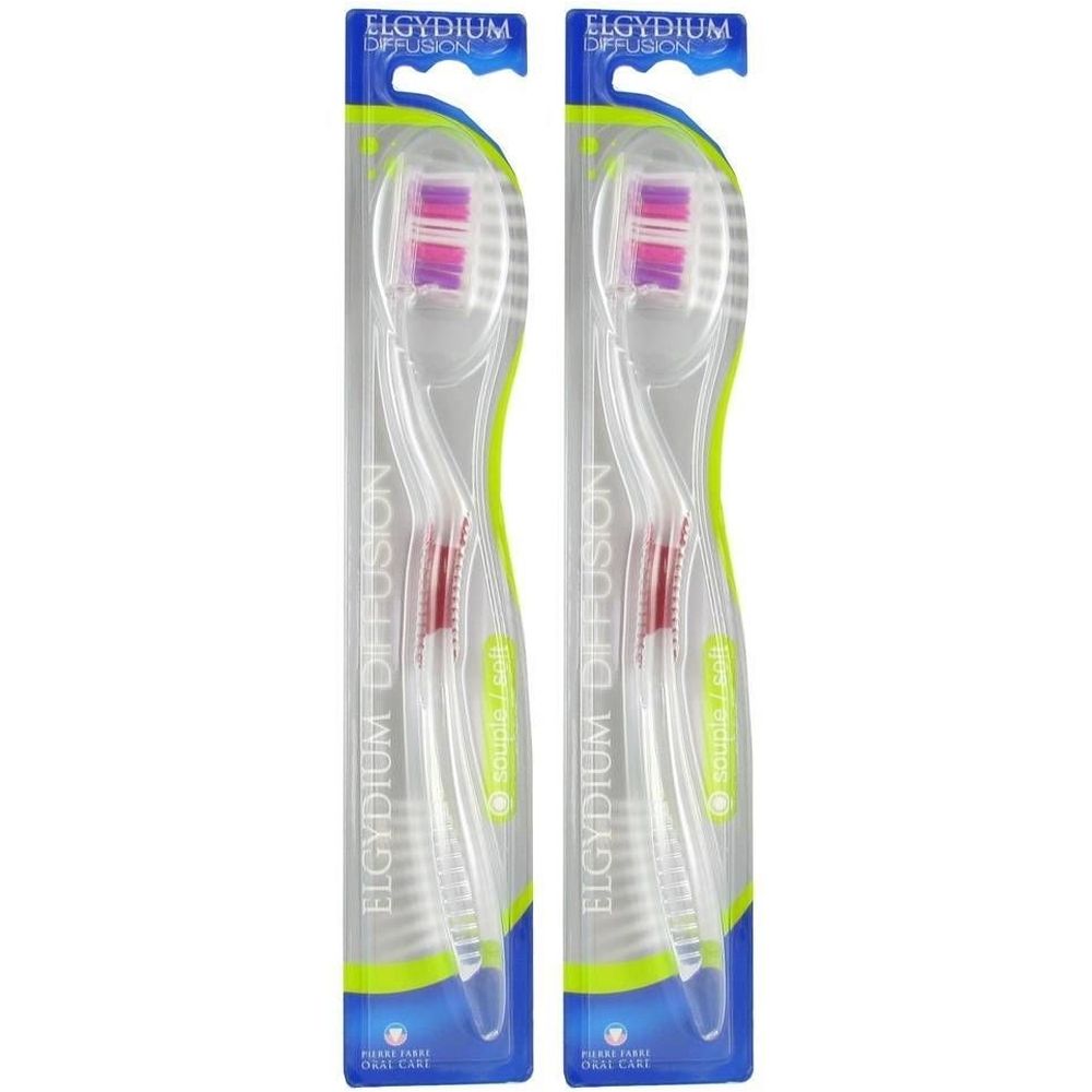 Deux brosses à dents emballées. Transparentes, blanches, avec des poils colorés. Inscription : Elgydium Diffusion, Pierre Fabre Oral Care.