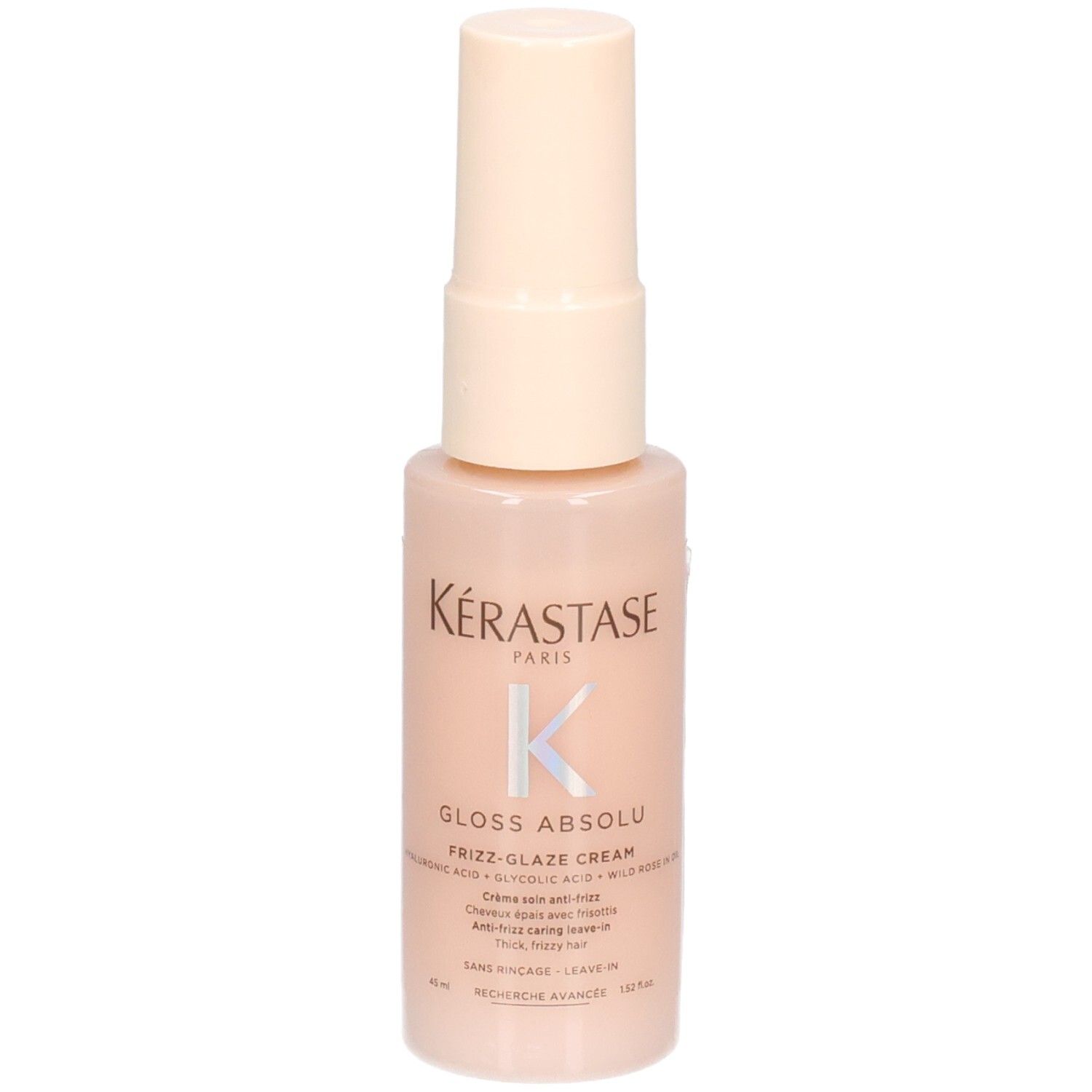Kérastase Gloss Absolu Frizz-Glaze Cream Mini in een perzikkleurige pompfles, licht schuin.