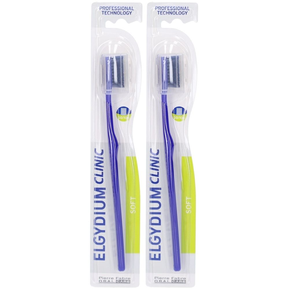 Deux brosses à dents sous blister. Manches bleues, poils gris. Inscription: ELGYDIUM CLINIC, SOFT. Emballage avec Professional Technology.