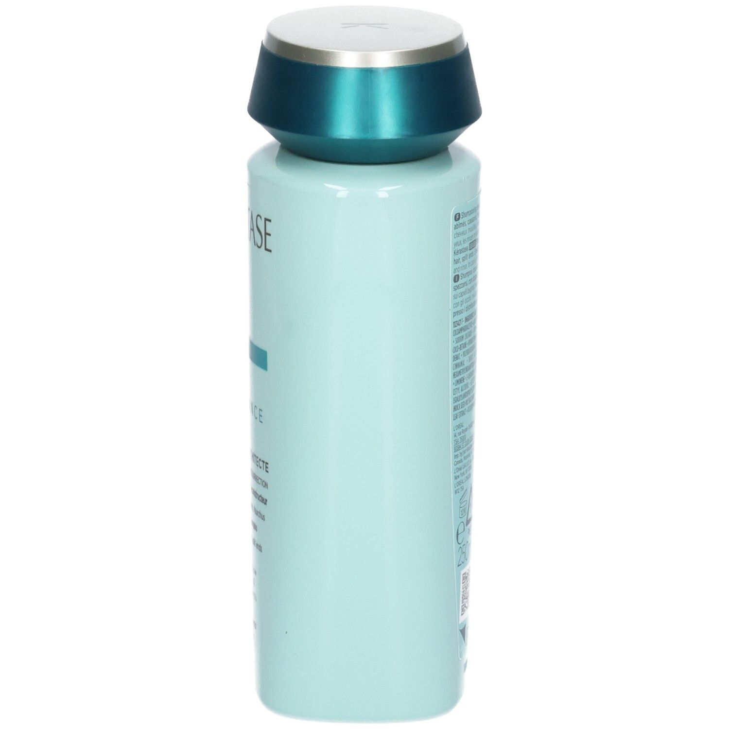 Zijaanzicht van de lichtblauwe Kérastase shampoo fles met turkooizen dop.