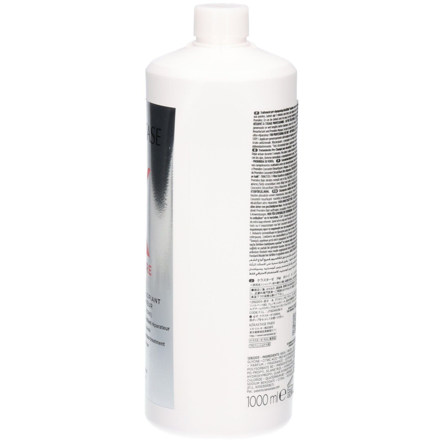 Zijkant van een witte fles met Kérastase Première etiket en tekstuele informatie.