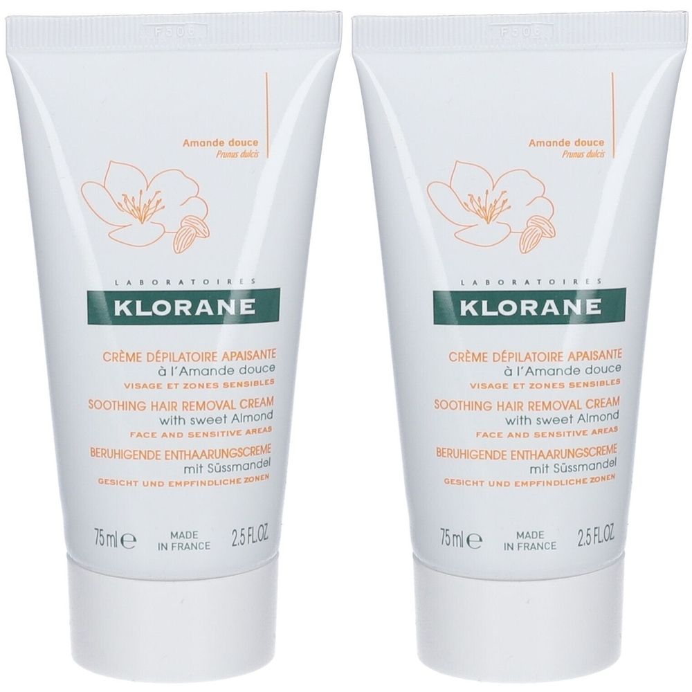 Deux tubes de crème dépilatoire KLORANE. Tubes blancs avec texte vert et illustration de fleur d'amande. Inscription: Crème dépilatoire apaisante.