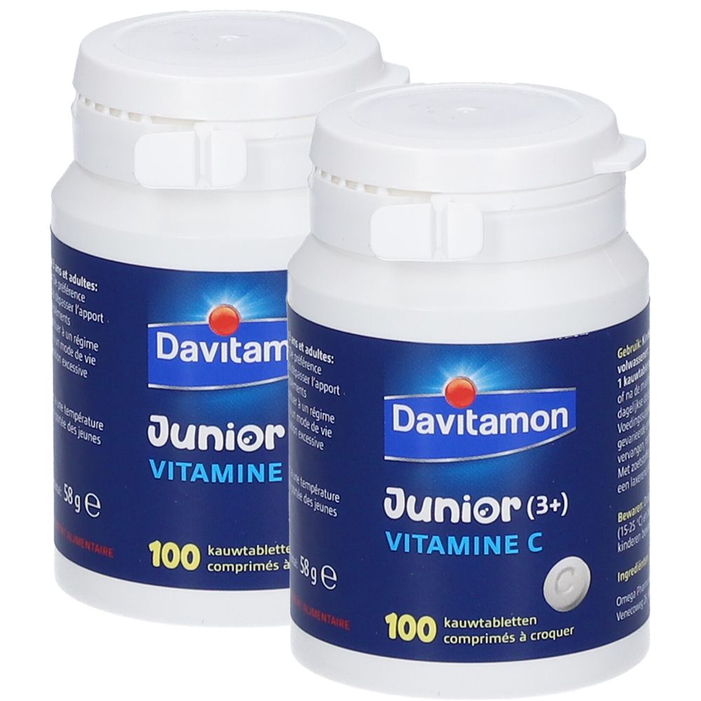 Twee witte flessen met blauwe etiketten. De etiketten tonen "Davitamon Junior Vitamine C" en "100 kauwtabletten".