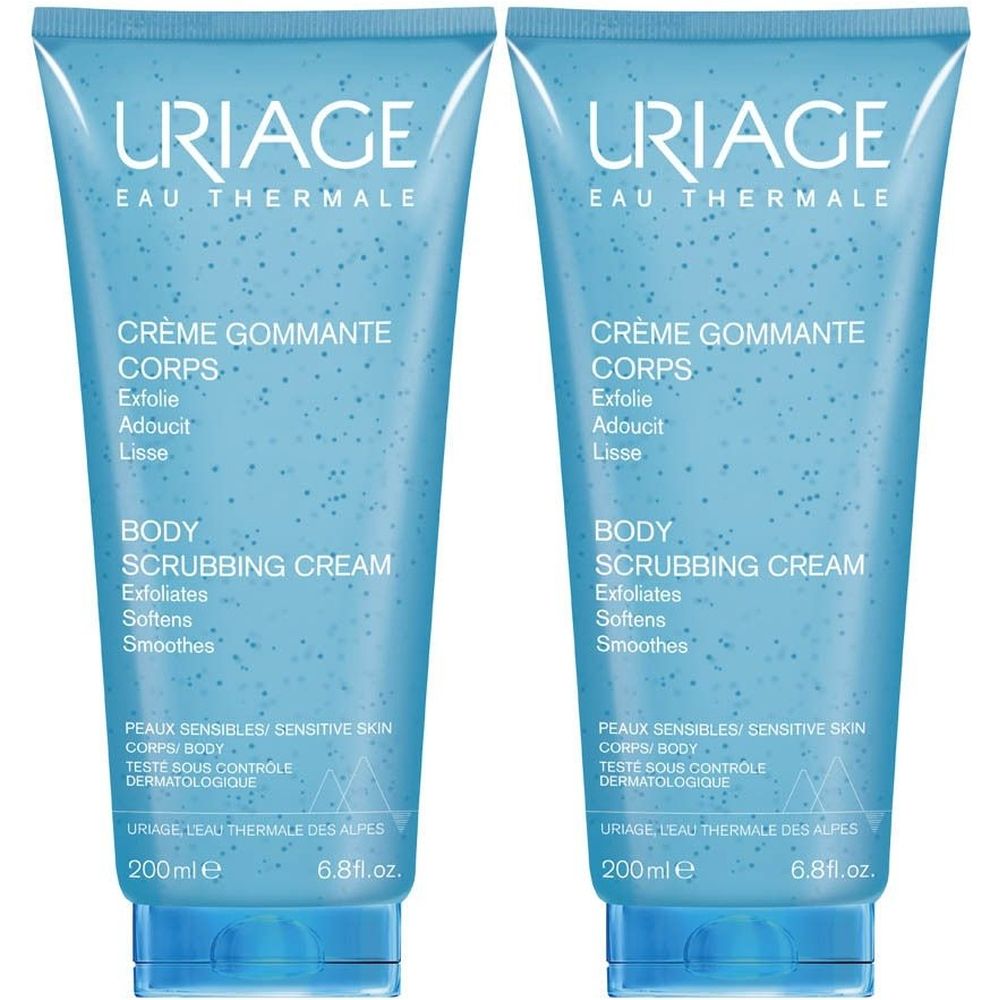 Deux tubes bleus de crème gommante Uriage. Inscription: Crème Gommante Corps, Body Scrubbing Cream. Pour peaux sensibles.